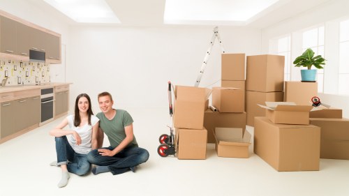 Packed boxes and furniture ready for loading into a moving van
